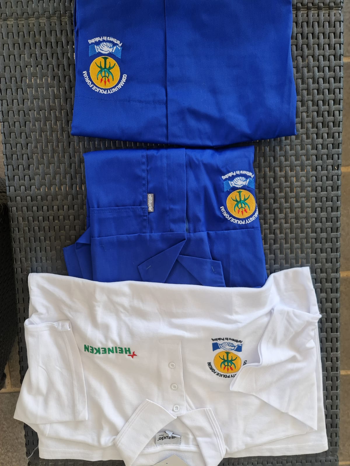 Blue branded workwear uniform pieces with embroidered crest