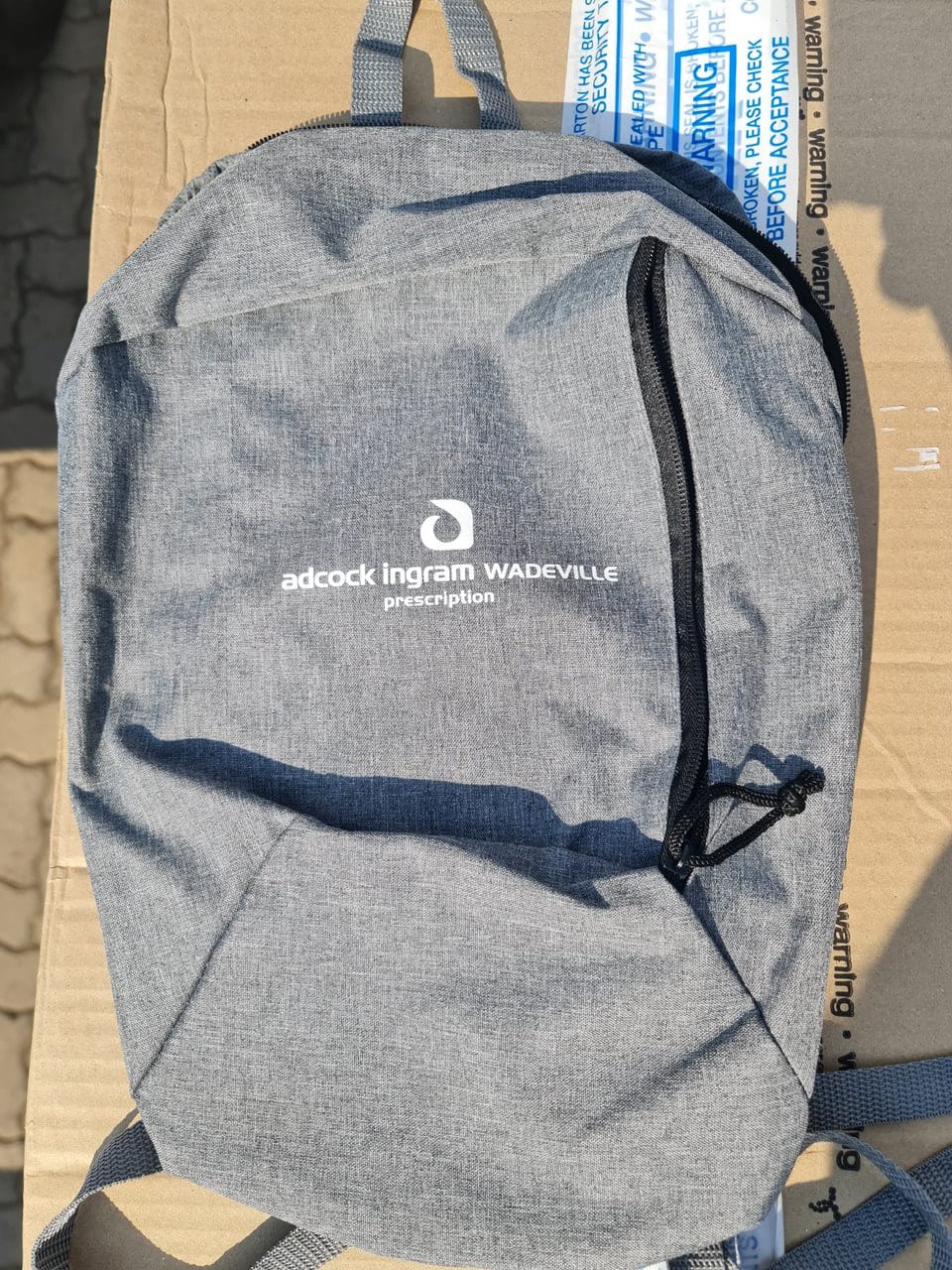 Grey branded backpack prepared for employee or client gifting