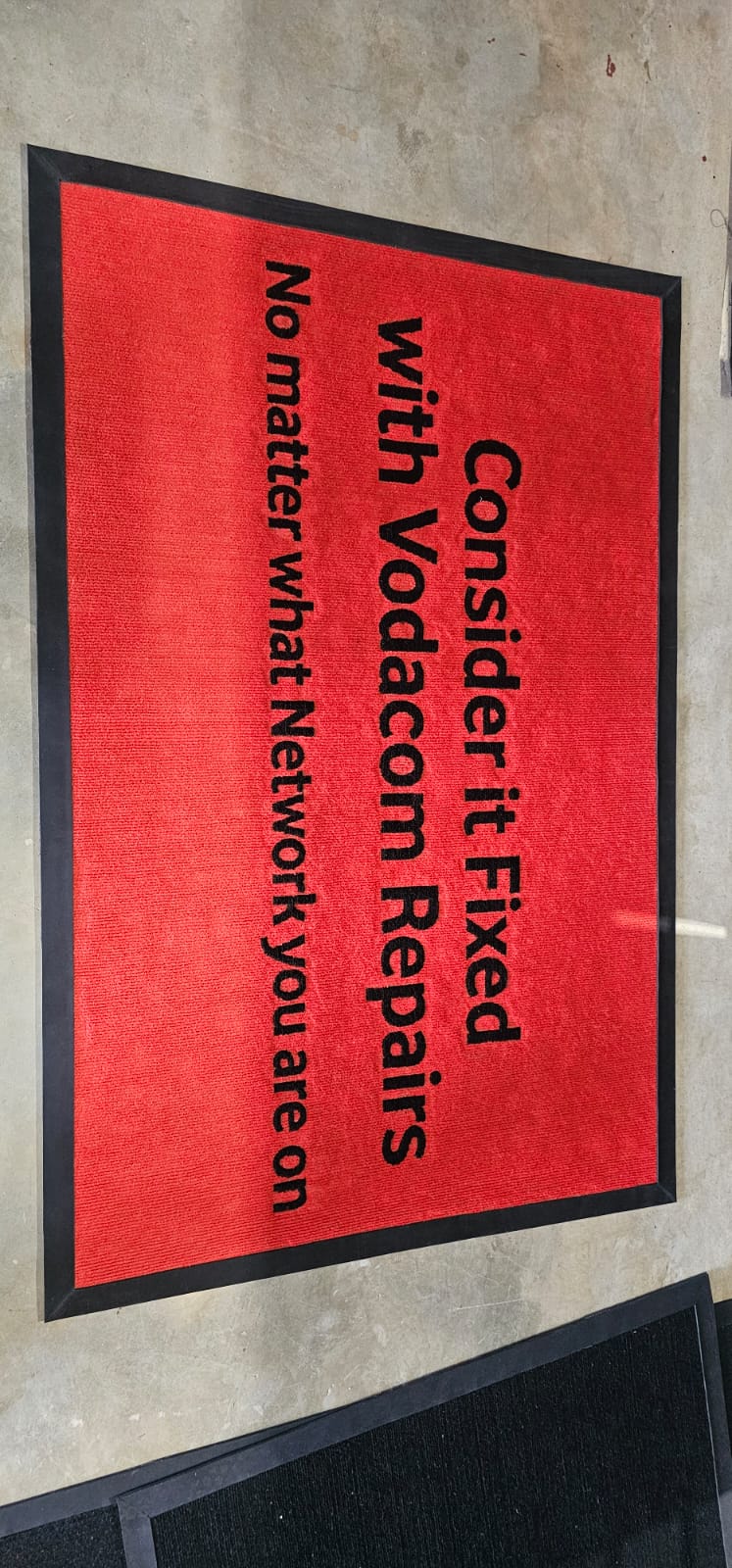 Framed branded print signage prepared for an indoor corporate campaign
